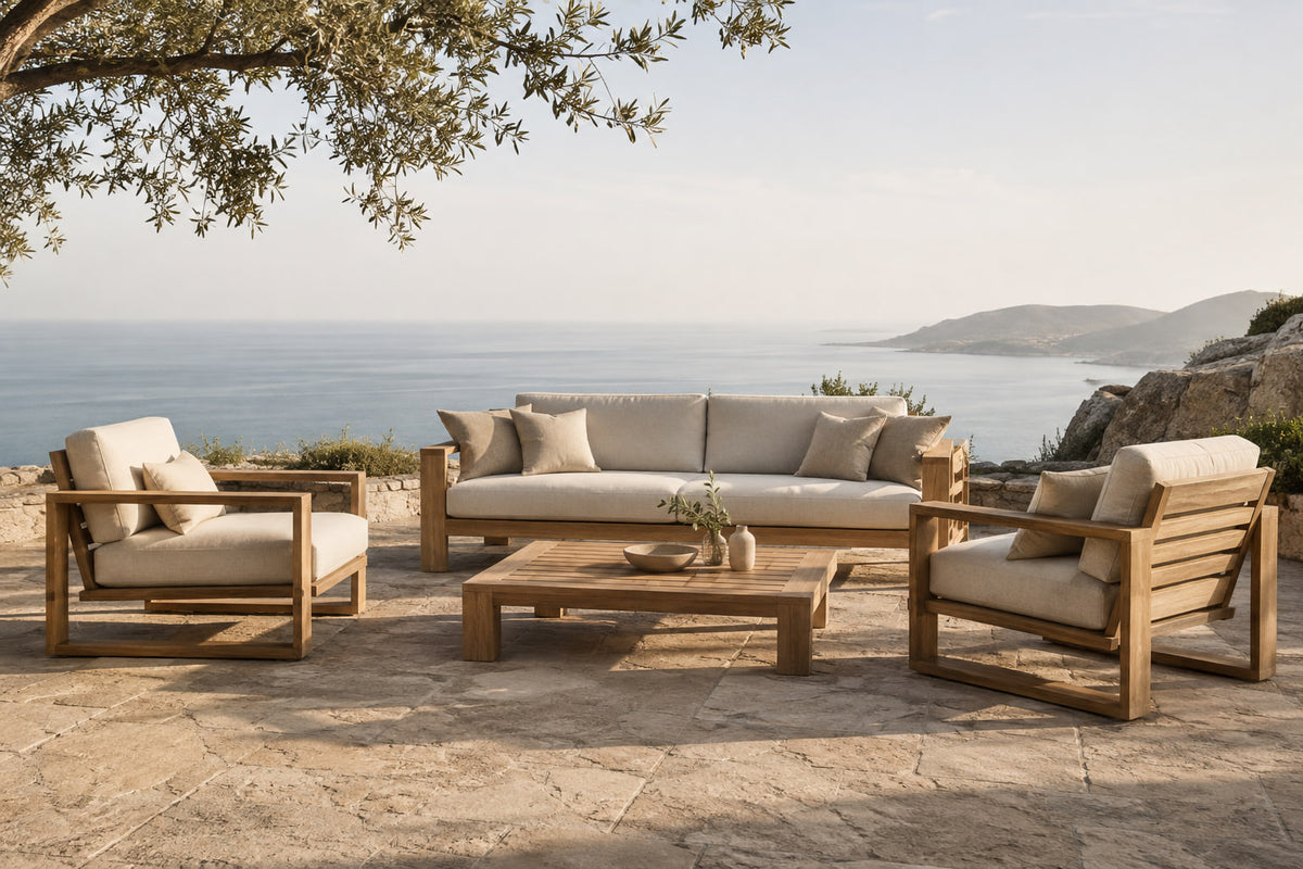 Vela in teak on a stone terrace on a headland with a hazy sea horizon
