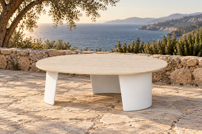 Lifestyle view: Luna aluminium coffee table with a pale stone top on a coastal terrace