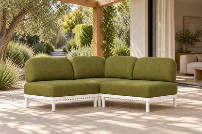 Lifestyle view: Luna modular corner sofa in aluminium on a garden terrace beside an open living room.