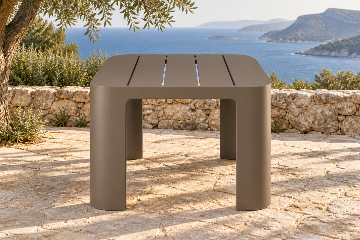Lifestyle view: Serein aluminium dining table on a coastal stone terrace