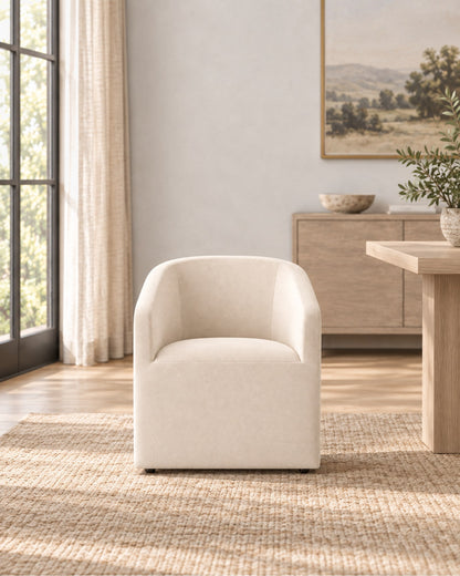 Ellison Barrelback Slope Arm Fabric Dining Armchair in a styled setting