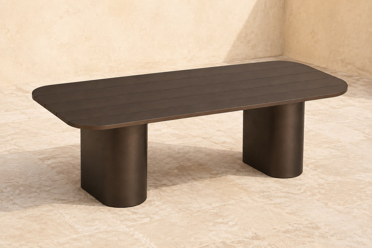Ethereal Dining Table in Aluminium, photographed in a quiet outdoor courtyard