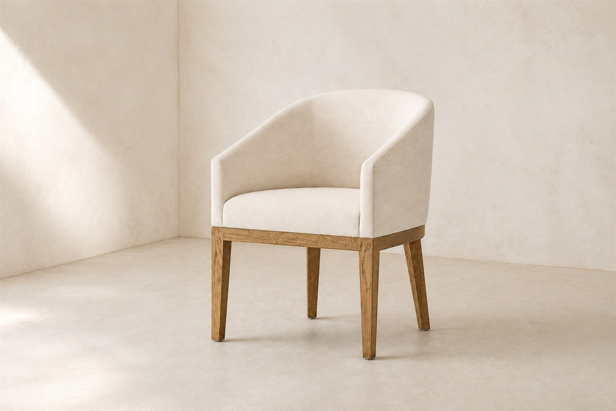 Morgan Barrelback Slope Arm Fabric Dining Armchair, photographed in a quiet dining room