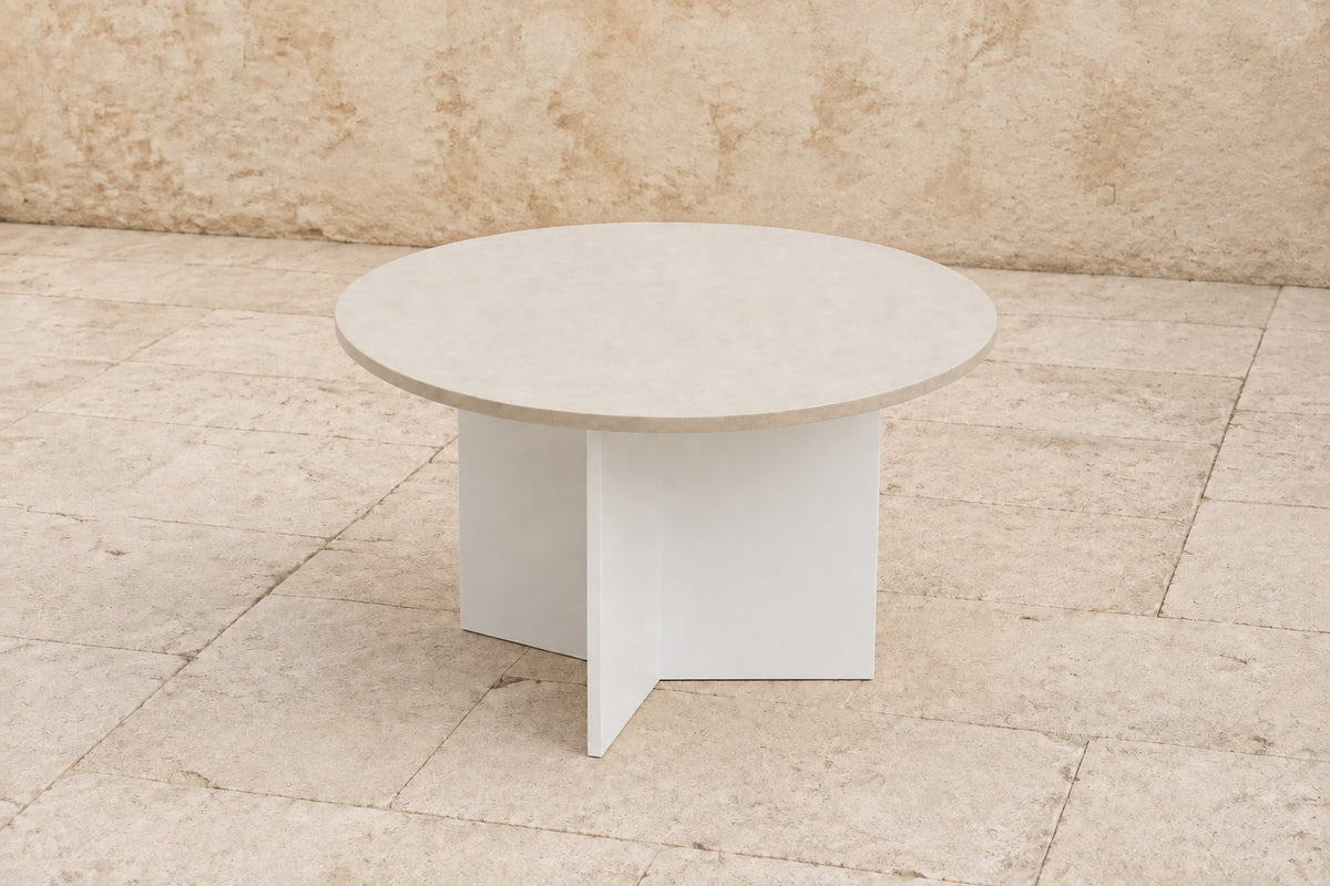 Vela Coffee Table in Aluminium, photographed in a quiet outdoor courtyard