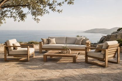 Vela in teak on a stone terrace on a headland with a hazy sea horizon