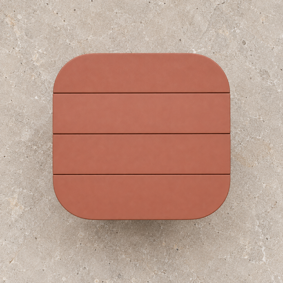Aria aluminium side table, overhead view on a stone terrace