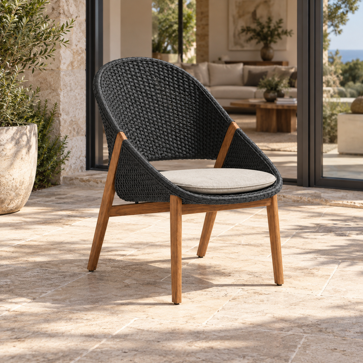 Lifestyle view: Cascais Lounge Chair, photographed in a quiet outdoor courtyard