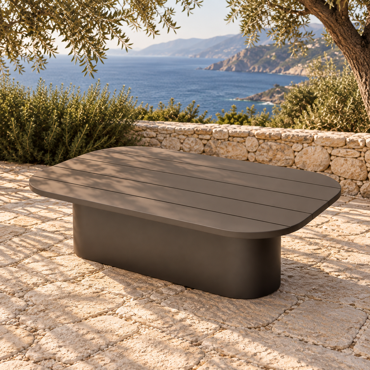 Lifestyle view: Ethereal Coffee Table in Aluminium, elevated diagonal view on a coastal stone terrace