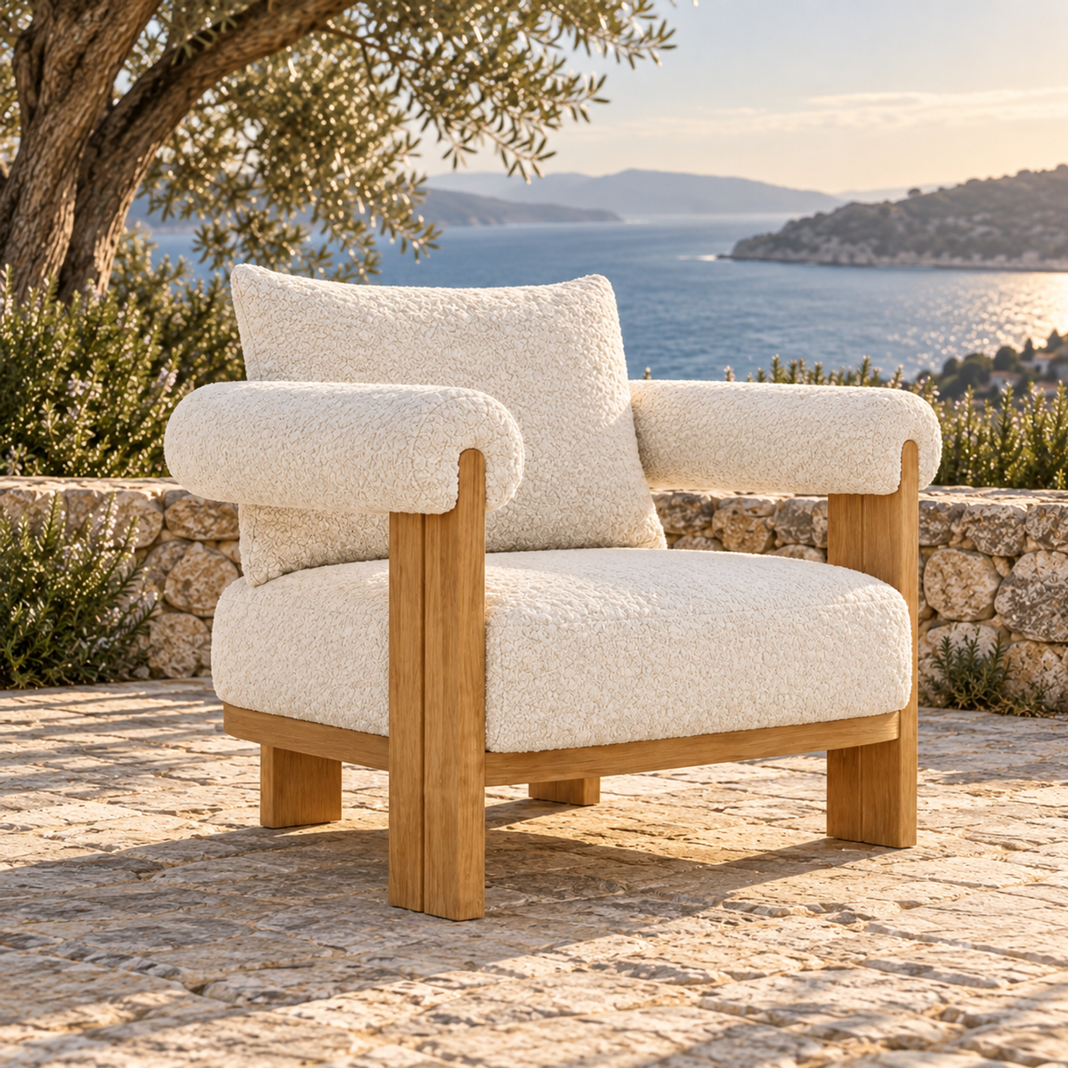 Lifestyle view: Ethereal Lounge Chair in Teak, opposite three-quarter view on a coastal stone terrace