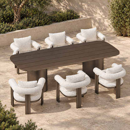 Lifestyle view: Ethereal aluminium dining table and six chairs, elevated diagonal on a planted terrace