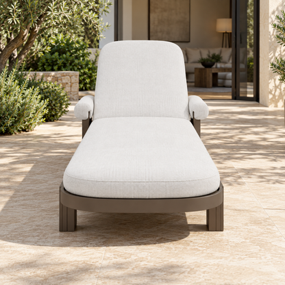 Lifestyle view: Ethereal Sun Lounger in Aluminium, straight foot-end view beside a furnished home