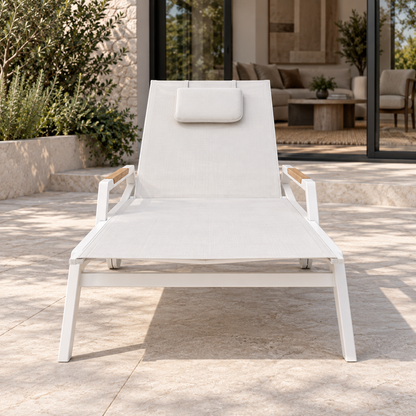 Lifestyle view: Faro Sun Lounger, photographed in a quiet outdoor courtyard