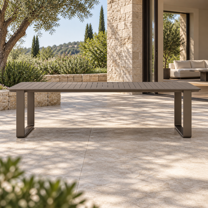 Grace aluminium dining table, straight long-side front view on a furnished home terrace