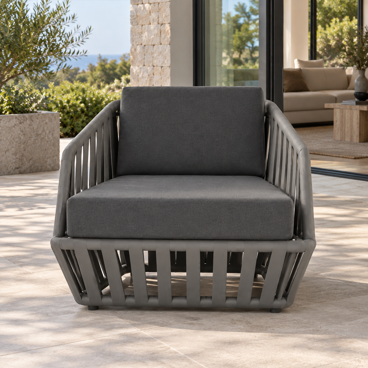 Lifestyle view: Mykonos Lounge Chair, photographed in a quiet outdoor courtyard