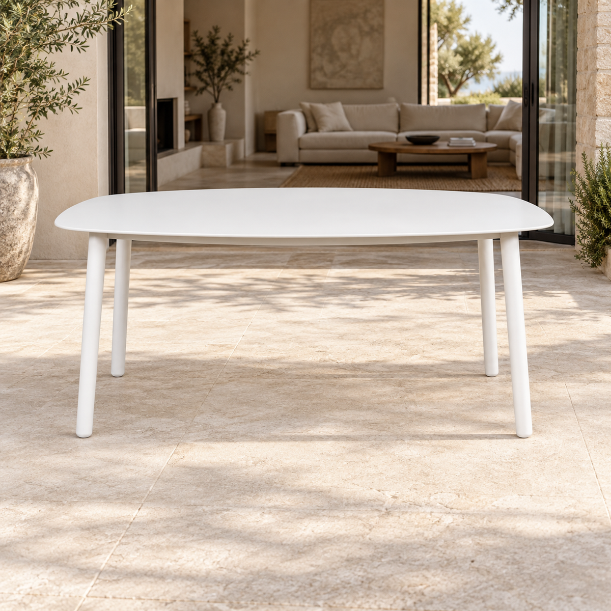 Lifestyle view: Paros Dining Table, photographed in a quiet outdoor courtyard