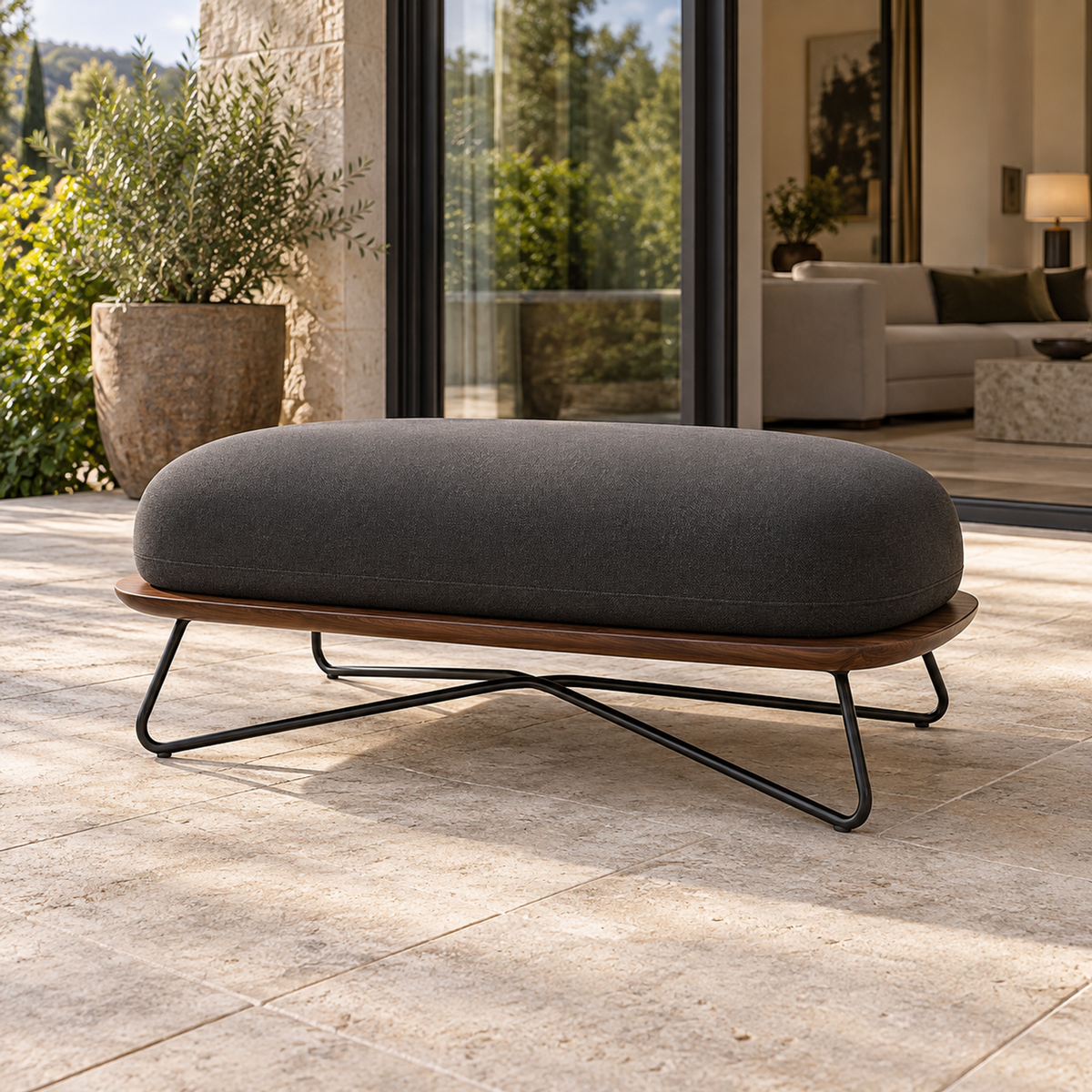 Lifestyle view: Positano Ottoman, photographed in a quiet outdoor courtyard