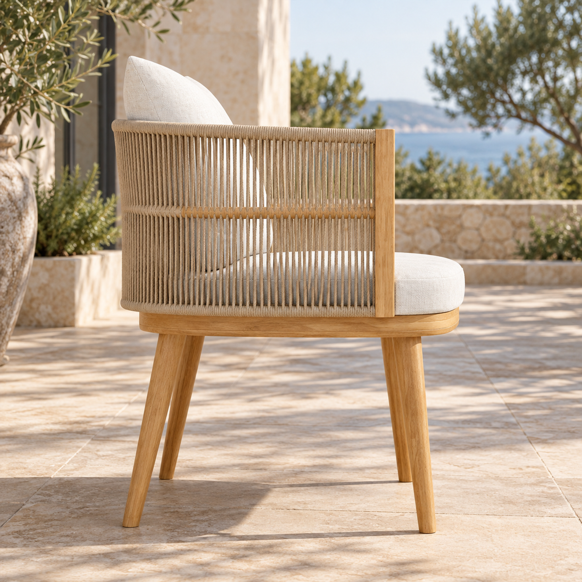 Lifestyle view: Ripple Dining Chair in Teak, side profile on a coastal terrace