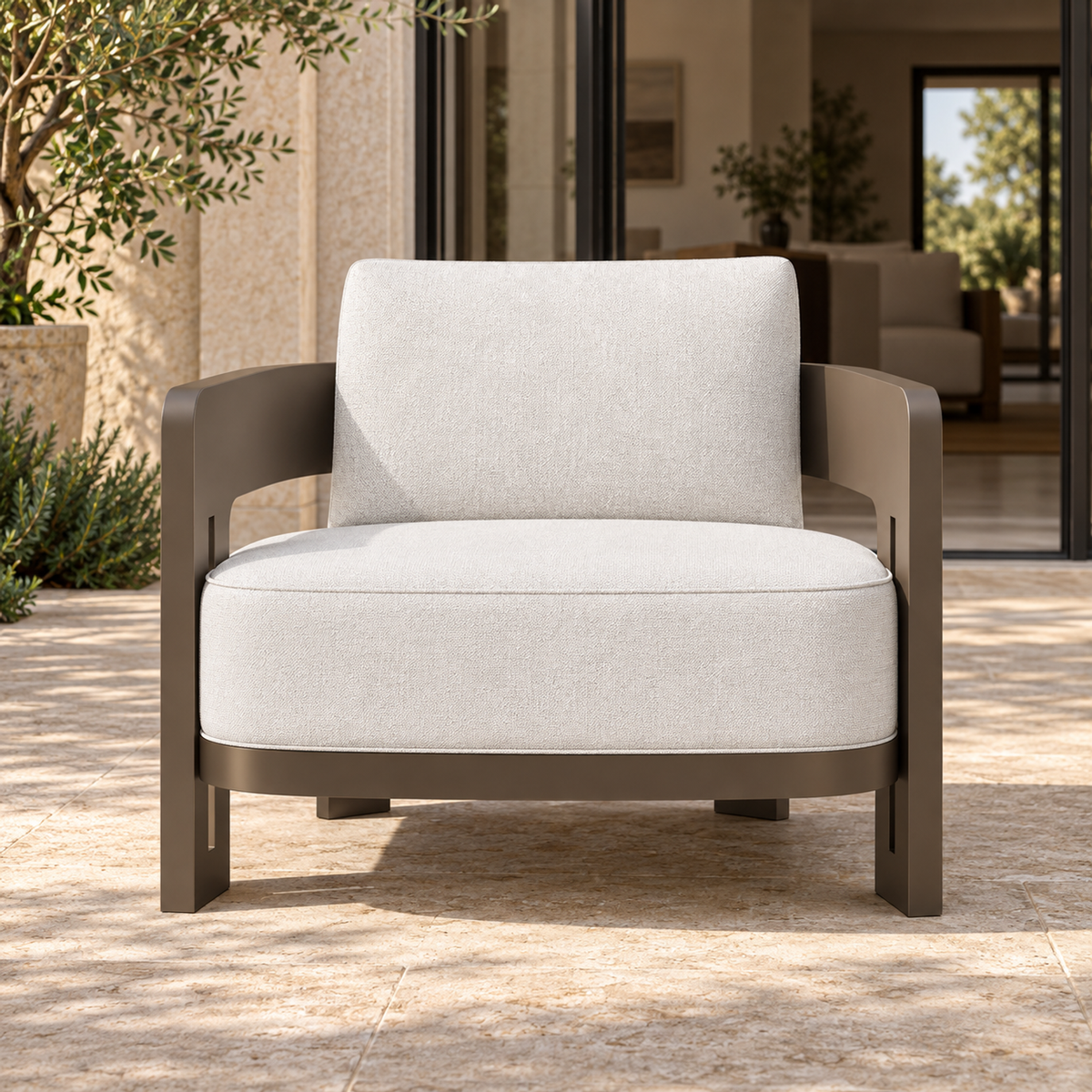Serein aluminium lounge chair, straight front view beside a furnished home