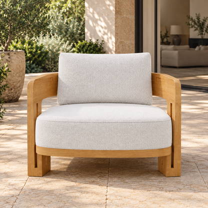 Serein teak lounge chair, straight front on a planted home terrace