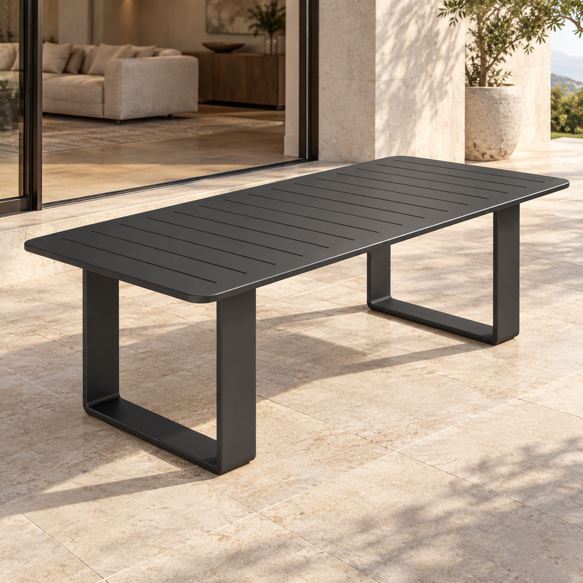 Lifestyle view: Zenia aluminium dining table beside a planted garden and furnished home
